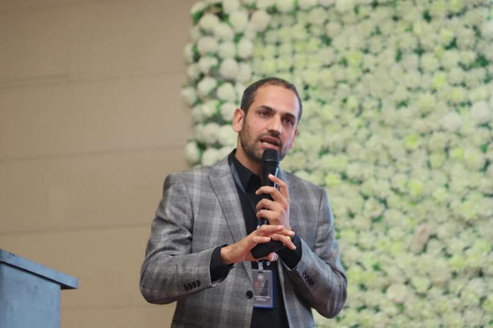 Dr Khan speaking at an event